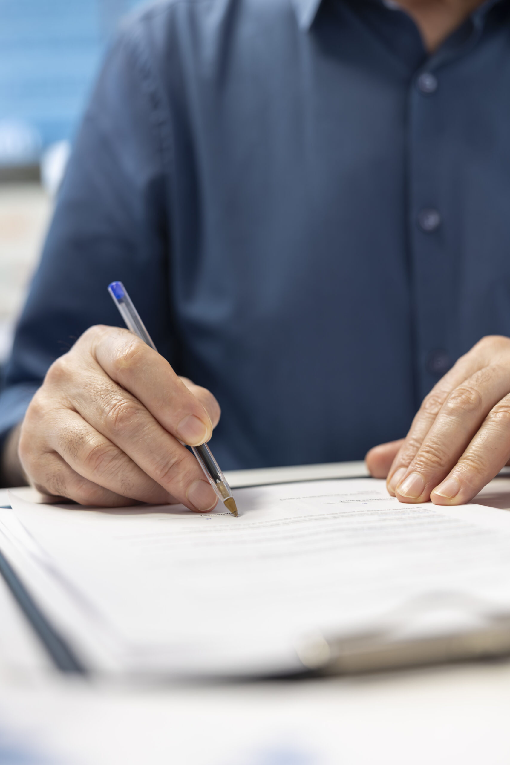 Senior man signing the financial contract with advisor expert