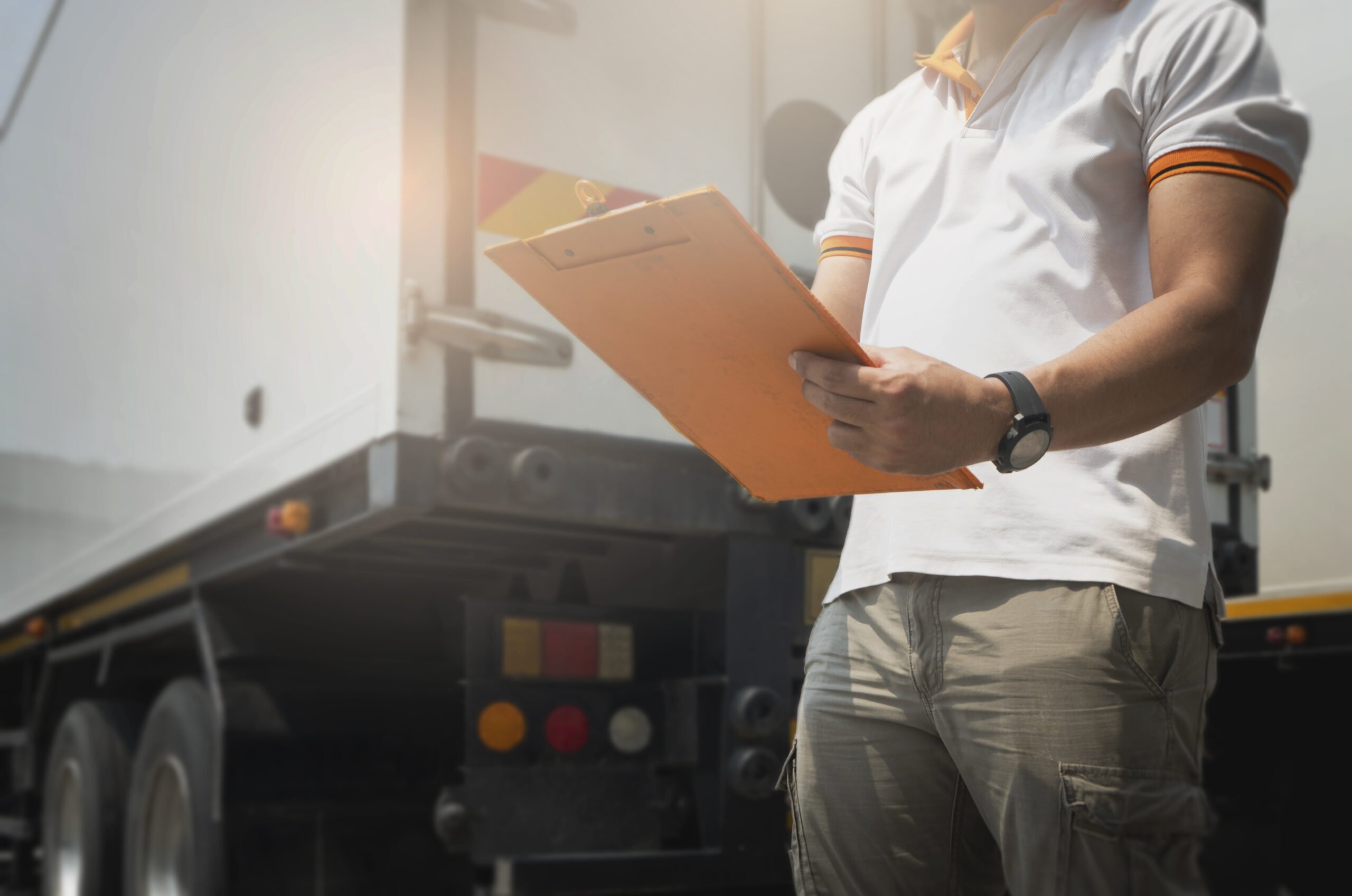 truck-driver-writing-paper-clipboard-standing-with-trailer-truck-maintenance-vehicle-safety-inspection