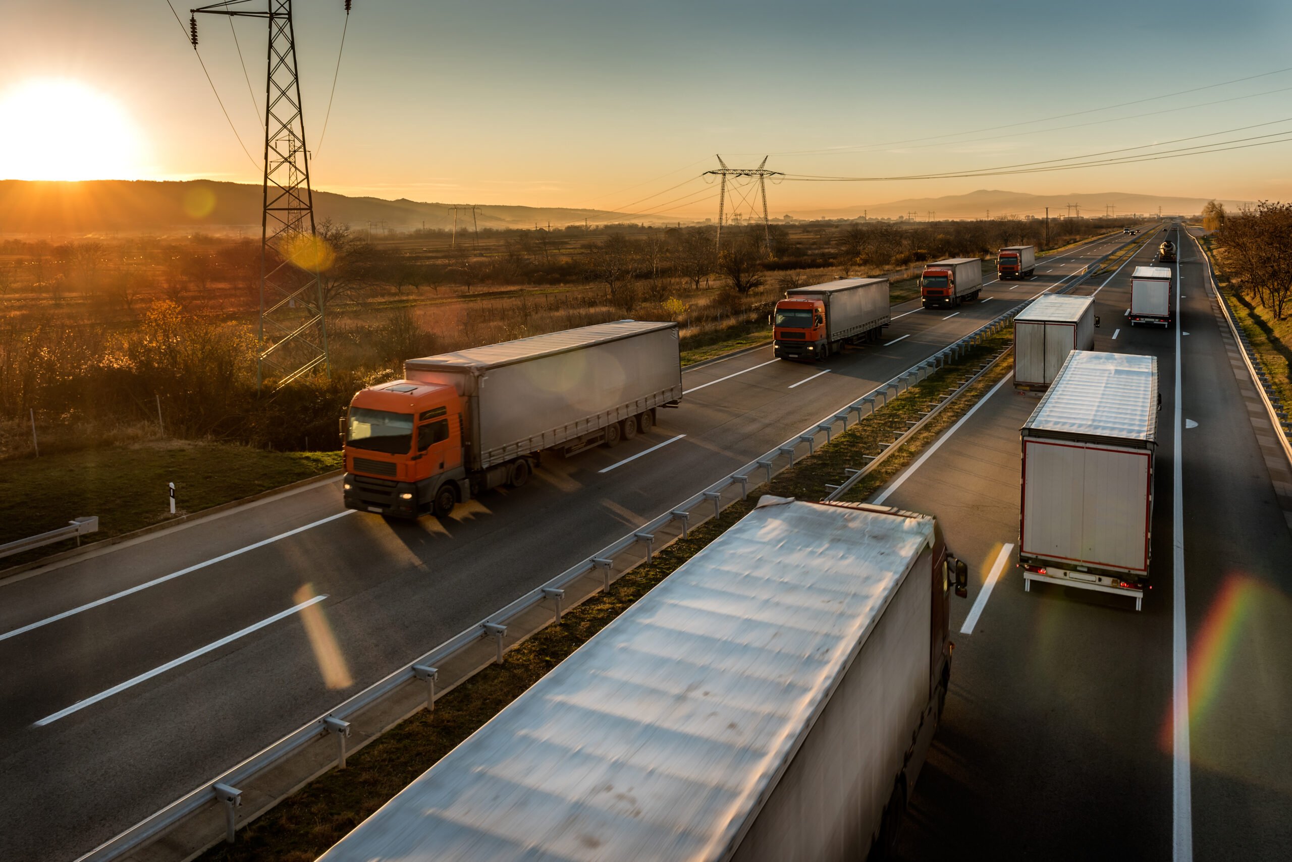 vehicles-road-against-sky-sunset
